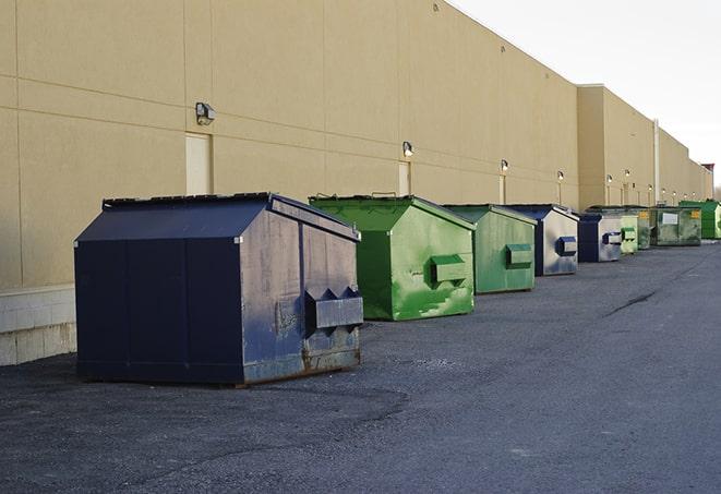 construction dumpsters stacked in a row on a job site in Enon